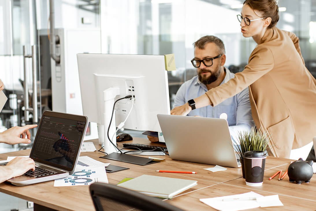 Two people having a conversation in office